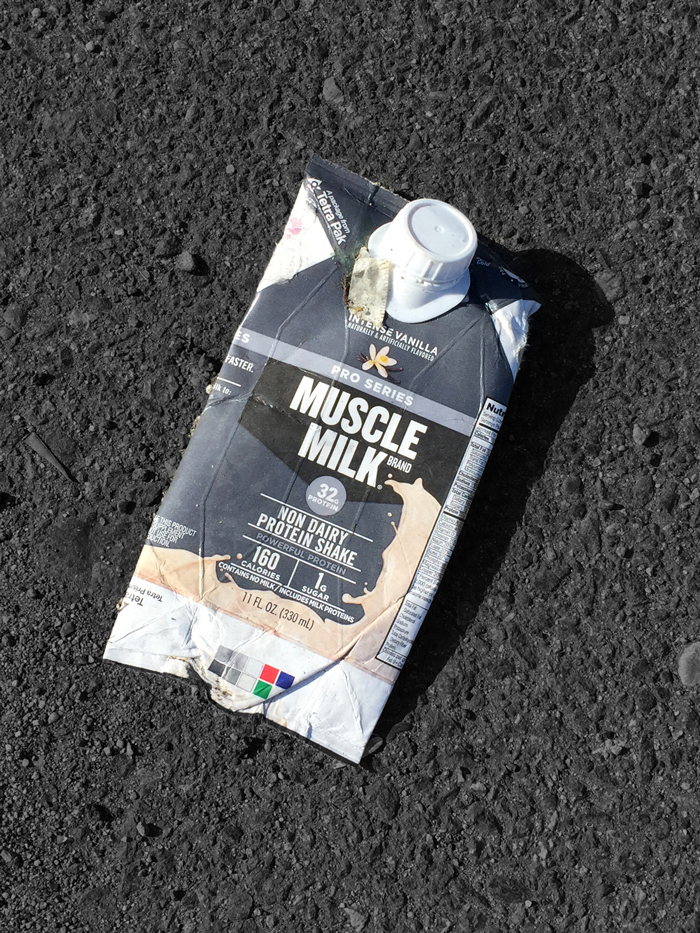 pressed single-serve carton of Intense Vanilla Muscle Milk in road