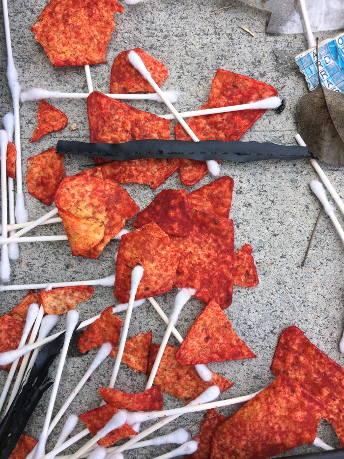 Flamin' Hot Doritos and Q-Tips scattered on ground