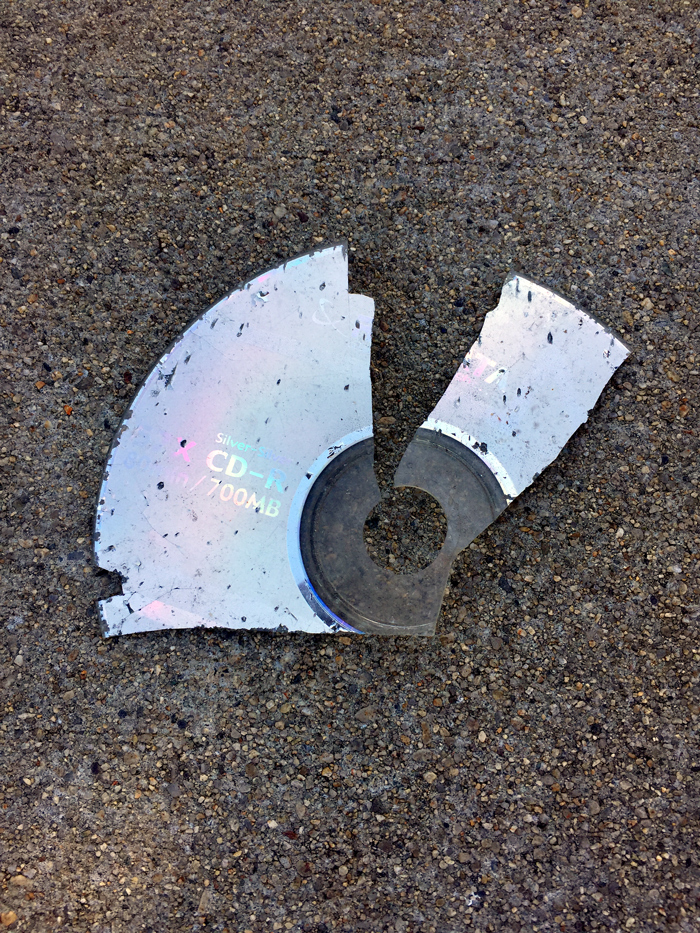 broken CD in street