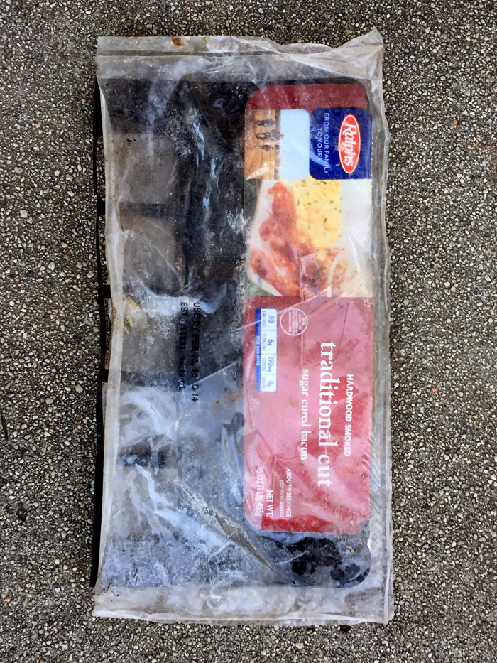 empty package of Traditional Cut bacon in street