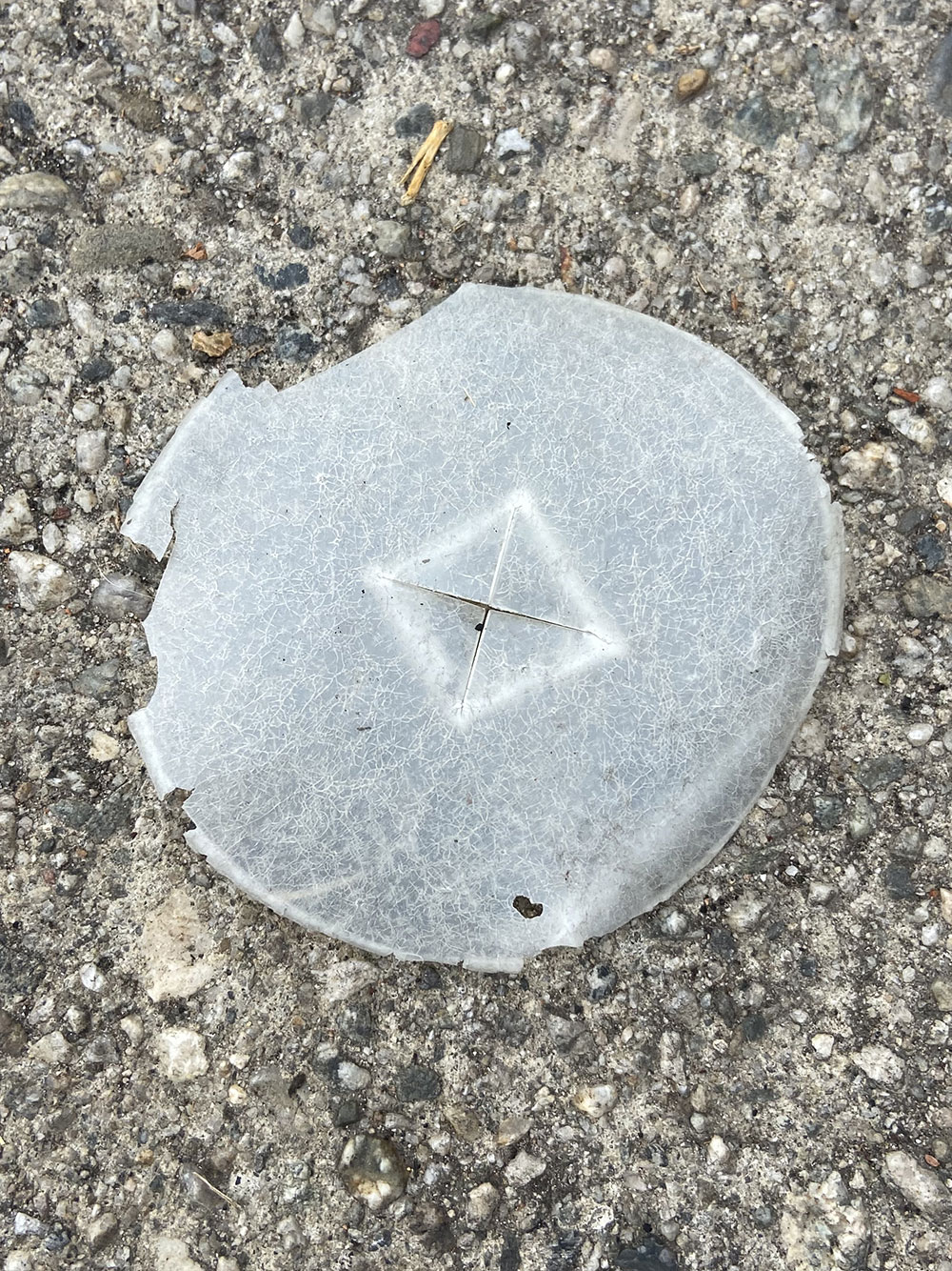piece of plastic from the top of a to-go soda cup